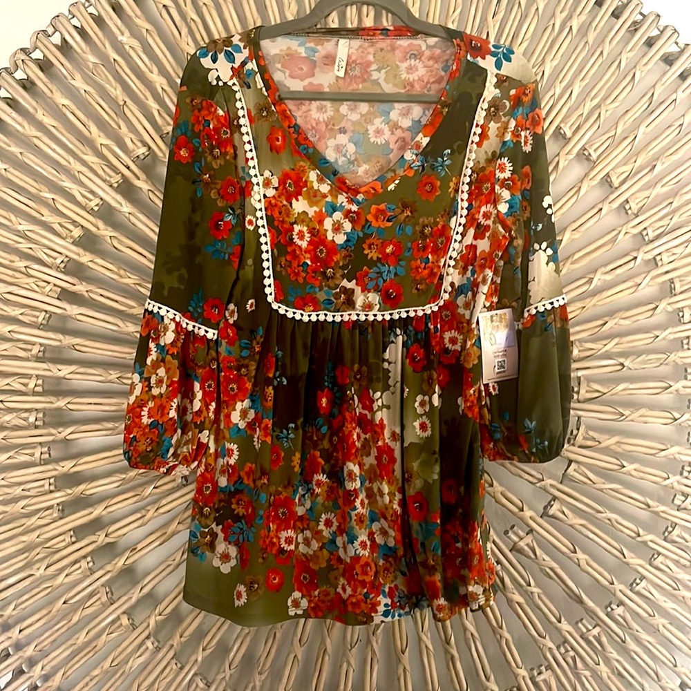 Size Medium multi color tunic with lace trim.  Mid balloon sleeve.